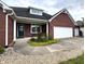 Close up of the home's entry way with a well-manicured garden in front of the two-car garage at 1019 White Oak Dr, Plainfield, IN 46168