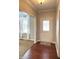 Inviting foyer with hardwood floors, a decorative rug and a view into the living room with neutral carpet at 1019 White Oak Dr, Plainfield, IN 46168