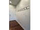 Inviting entryway features hardwood floors, white wainscoting with black hooks and a neutral wall color at 1019 White Oak Dr, Plainfield, IN 46168