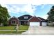 Charming brick home with a well-manicured lawn, a two-car garage and a welcoming front yard at 1019 White Oak Dr, Plainfield, IN 46168