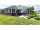 Charming home exterior featuring a screened-in patio, brick, a well-manicured lawn and lush landscaping at 1019 White Oak Dr, Plainfield, IN 46168
