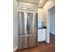 Stainless steel refrigerator adjacent to plenty of white cabinets and countertop space at 1019 White Oak Dr, Plainfield, IN 46168
