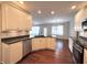 Spacious kitchen featuring stainless appliances, tiled backsplash, lots of storage, and hardwood flooring at 1019 White Oak Dr, Plainfield, IN 46168