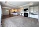Cozy living room with built-in bookshelves, a fireplace, and an adjacent modern kitchen at 1019 White Oak Dr, Plainfield, IN 46168