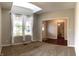 Bright living room featuring neutral carpet, large windows with a view and entry way with hardwood floors at 1019 White Oak Dr, Plainfield, IN 46168