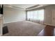 Carpeted living room with large windows providing ample natural light and hardwood entry at 1019 White Oak Dr, Plainfield, IN 46168
