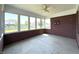 Bright sunroom featuring brick walls, neutral flooring, and large windows providing lots of natural light at 1019 White Oak Dr, Plainfield, IN 46168