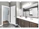 Full bathroom featuring double sinks, dark cabinets and shower/tub combo at 10215 Lauren Pass, Fishers, IN 46037