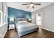 Cozy bedroom featuring a ceiling fan, hardwood floors, and full bath en suite at 10215 Lauren Pass, Fishers, IN 46037