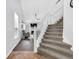 Elegant entryway with hardwood floors, a staircase, and a view into the cozy living room at 10215 Lauren Pass, Fishers, IN 46037