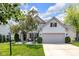 Inviting front yard with mature trees, landscaping, and a cozy seating area by the front door at 10215 Lauren Pass, Fishers, IN 46037