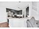 Modern kitchen featuring dark cabinets, stainless steel appliances, and a breakfast bar at 10215 Lauren Pass, Fishers, IN 46037