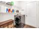 Convenient laundry room with modern washer and dryer, shelving, and white door at 10215 Lauren Pass, Fishers, IN 46037