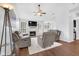 Spacious living room with a fireplace, large windows, and comfortable seating at 10215 Lauren Pass, Fishers, IN 46037