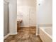 Bright bathroom features a shower, tub, vanity with tan countertop and a white door at 10216 Hatherley Way, Fishers, IN 46037