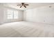 Spacious bedroom with neutral carpeting and ample natural light from two large windows at 10216 Hatherley Way, Fishers, IN 46037