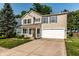 Charming two-story home with blue shutters, a well-manicured lawn, and an attached two-car garage at 10216 Hatherley Way, Fishers, IN 46037