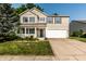 Charming two-story home with blue shutters, a well-manicured lawn, and an attached two-car garage at 10216 Hatherley Way, Fishers, IN 46037