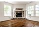 Cozy fireplace with stone surround and white trim in a well-lit room at 10216 Hatherley Way, Fishers, IN 46037