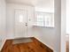 Bright foyer with hardwood floors and a white front door and trim at 10216 Hatherley Way, Fishers, IN 46037