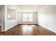Bright living room featuring hardwood floors and a large window at 10216 Hatherley Way, Fishers, IN 46037