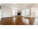 Bright open-concept living room with hardwood floors and a stone fireplace at 10216 Hatherley Way, Fishers, IN 46037