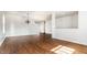 Bright and open living room featuring hardwood floors and an open stairway at 10216 Hatherley Way, Fishers, IN 46037