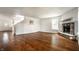 Spacious living room featuring hardwood floors and a stone fireplace at 10216 Hatherley Way, Fishers, IN 46037