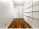 Spacious walk-in closet with wood floors and ample shelving for organized storage at 10216 Hatherley Way, Fishers, IN 46037