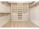 Spacious walk-in closet with custom shelving, drawers, and hanging rods for optimal organization at 10216 Hatherley Way, Fishers, IN 46037