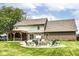 Beautiful backyard featuring a fire pit, patio area, pergola, manicured lawn and mature trees at 1031 W Morning Walk Dr, Greenfield, IN 46140