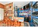 Finished garage space with a wood bar, tv, stools, shelving, fridge, and blue painted walls at 1031 W Morning Walk Dr, Greenfield, IN 46140