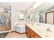 Bathroom featuring double sink vanity with marble countertop, soaking tub, and glass enclosed shower at 1031 W Morning Walk Dr, Greenfield, IN 46140