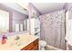 A bathroom featuring a wooden vanity with a marble countertop and neutral-colored shower curtain at 1031 W Morning Walk Dr, Greenfield, IN 46140