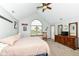 Bedroom featuring plush carpeting, a vaulted ceiling, dark wood furniture, and a large window at 1031 W Morning Walk Dr, Greenfield, IN 46140