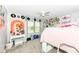 A bright bedroom featuring decor such as a ceiling fan and a window overlooking a green landscape at 1031 W Morning Walk Dr, Greenfield, IN 46140