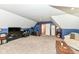 Open bonus room with neutral carpeting, natural light, and ample space for activities and storage at 1031 W Morning Walk Dr, Greenfield, IN 46140