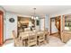 Open dining room with wood table and view into the living room with brick fireplace at 1031 W Morning Walk Dr, Greenfield, IN 46140