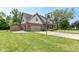 Side view of two-story home featuring a well maintained lawn and a basketball hoop at 1031 W Morning Walk Dr, Greenfield, IN 46140