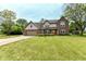 Charming two-story brick home with manicured lawn and basketball hoop on driveway at 1031 W Morning Walk Dr, Greenfield, IN 46140