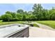 Backyard patio area featuring a relaxing hot tub and seating area with fire pit at 1031 W Morning Walk Dr, Greenfield, IN 46140