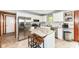 Bright kitchen featuring stainless steel appliances, white cabinets, and a spacious island with granite countertops at 1031 W Morning Walk Dr, Greenfield, IN 46140