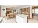 Open-concept kitchen showcasing an island with granite countertop and view of the adjacent dining and living areas at 1031 W Morning Walk Dr, Greenfield, IN 46140