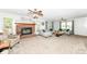 Bright living room featuring a brick fireplace, ceiling fan, and comfortable seating at 1031 W Morning Walk Dr, Greenfield, IN 46140