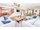 Open-concept living room with comfortable seating, fireplace, and access to other living spaces at 1031 W Morning Walk Dr, Greenfield, IN 46140