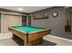 This recreational room in the basement includes a pool table, dart board, and beer steins at 10380 Sand Creek Blvd, Fishers, IN 46037