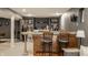 A basement with a bar area has a marble countertop, wood cabinets, and two chairs at 10380 Sand Creek Blvd, Fishers, IN 46037