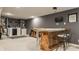 This finished basement has a bar with a countertop, a guitar, and a mini refrigerator at 10380 Sand Creek Blvd, Fishers, IN 46037