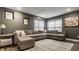 A finished basement has a gray sectional couch, a modern area rug, and recessed lighting at 10380 Sand Creek Blvd, Fishers, IN 46037
