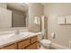 Bathroom featuring a marble countertop, wood vanity, and a shower in the background at 10380 Sand Creek Blvd, Fishers, IN 46037